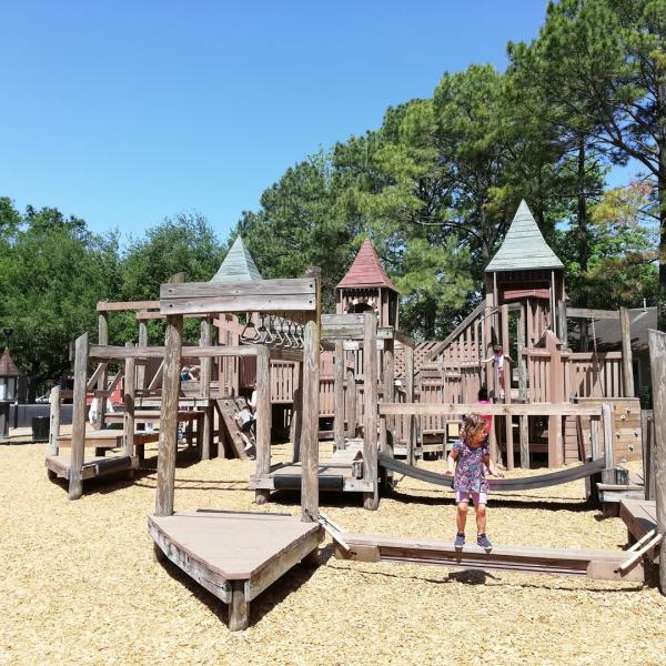 A wooden play area at Donovan Park in Houston, TX